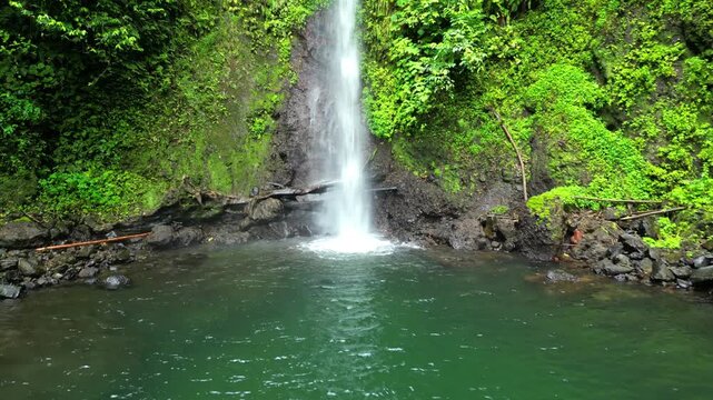 Flying backwards with view of the Bombaim waterfall hidden in the middle of the African forest,S&atilde;o Tom&eacute;,Africa
