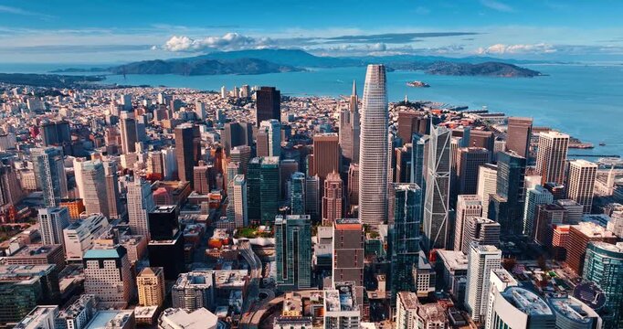Scenery of high-rise downtown San Francisco, California, USA at daytime. Blue waterscape with rocks at backdrop. Aerial view.
