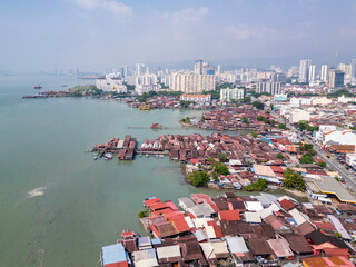 Penang, Malaysia: Aerial drone view of the Georgetown seafront with the famous ancient Clan jetty, wooden stilt houses for Chinese immigrants