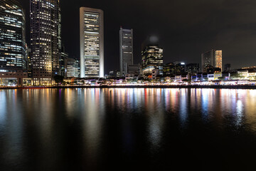 Singapore: Business skyscrapers rise above the boat quay entertainement district at night along the Singapore river in Southeast Asia financial center