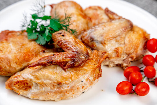 Authentic Georgian Chicken Tabaka: Vibrant Presentation on a White Plate. Close-up