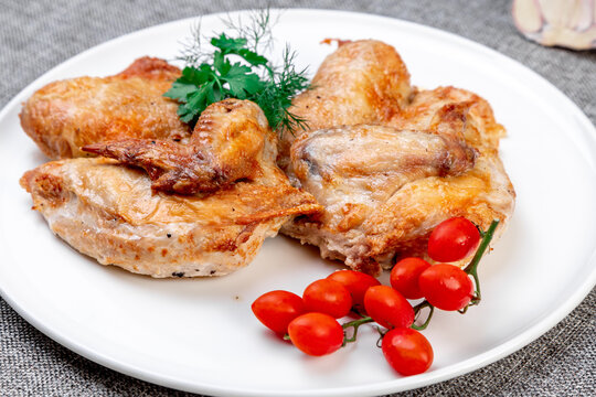Authentic Georgian Chicken Tabaka: Vibrant Presentation on a White Plate. Close-up