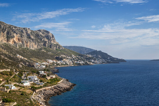 Mountainous and rugged landscape, coastline and the Aegean Sea towards the village of Masouri (Massouri) on Kalymnos island in Greece on a sunny day.