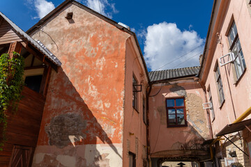 Old European courtyard with weathered peach and orange buildings
