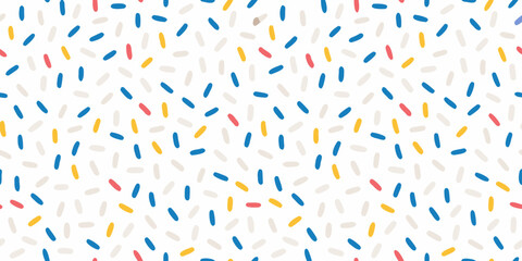 Colorful confetti sprinkles scattered across a bright white background
