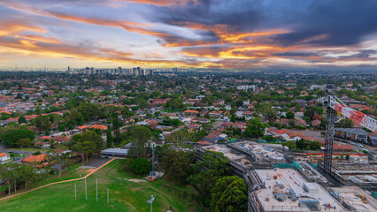 Obraz premium Panoramic Aerial Drone view of Inner Western Suburbs of Sydney housing, roof tops, the streets and the parks, the roads and trees of Ashbury Ashfield Burwood Summer Hill Canterbury and Campsie in Sydn
