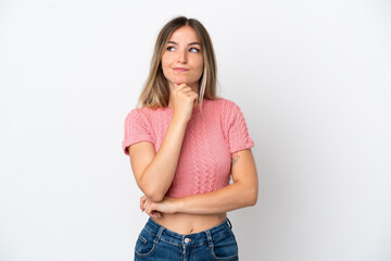 Young Romanian woman isolated on white background having doubts and thinking