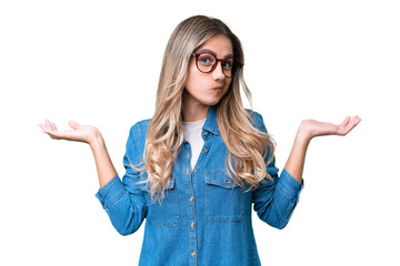 Young Uruguayan woman over isolated background having doubts while raising hands