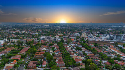 Obraz premium Panoramic Aerial Drone view of Inner Western Suburbs of Sydney housing, roof tops, the streets and the parks, the roads and trees of Ashbury Ashfield Burwood Summer Hill Canterbury and Campsie in Sydn