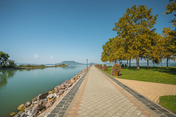 Balaton lakeside promenade with autumn trees and calm water in Hungary © petrsvoboda91