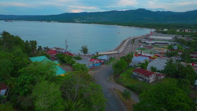 Wewak Bay Boram Road Sea Wall boats cars fishing Meni Boram Beach costal town Wewak Hill Papua New Guinea PNG Papua Niugini harbor view landscape East Sepik Province coastline sunset forward pan up