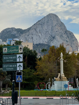 Avenida Juan Carlos I, 15, 03710 Calpe, Alicante, Spain.
traffic in the city center, signs. banners with the name of the city. City in Spain .road to the mountain