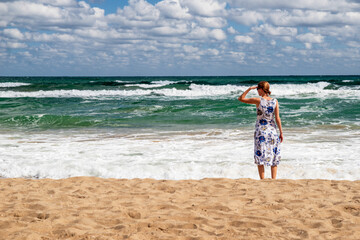 Woman standing on sandy beach watching waves - Black Sea coast in Obzor Bulgaria summer © Jaroslav Moravcik