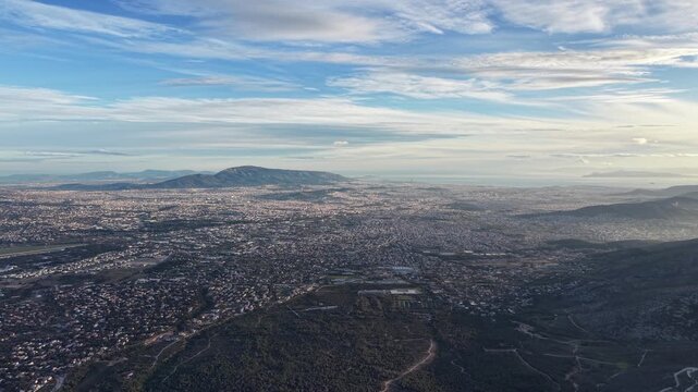 Captured in February from 1200m above Regency Casino Mont Parnes on Mount Parnitha, this drone footage reveals Athens' vast urban expanse below. Slowly retreating backward,