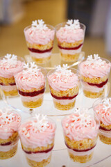 Fototapeta premium Colorful dessert cups with layers of cream, jelly, and snowflake decor