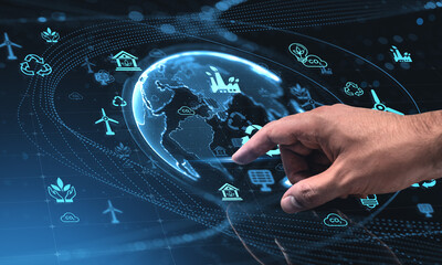 Human hand interacting with futuristic glass screen displaying a hologram of Earth and...