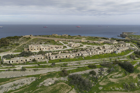Aerial view of the stark, weathered Fort Campbell, a relic against the backdrop of the shimmering sea, its stone walls echoing tales of time and tide, Mellieha, Malta.