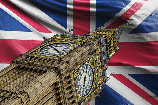 Dramatic low-angle view of the Elizabeth Tower (Big Ben) and its ornate clock face against a waving Union Jack flag background. Concept image for British identity, politics, heritage, travel and touri