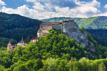 &bdquo;Orava Castle in Slovakia at night, famous filming location of the 1922 silent horror film Nosferatu. Dramatic gothic medieval castle on a rocky cliff with dark mysterious atmosphere.&ldquo;