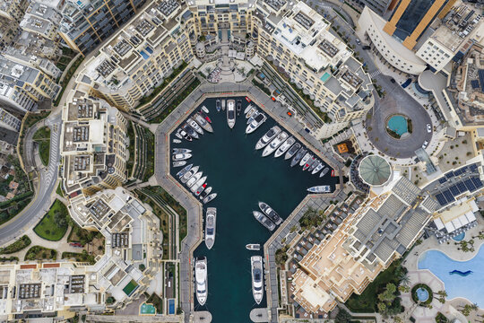 Aerial view of yachts nestled in the vibrant Portomaso Marina, a jewel of azure waters embraced by luxury residences, St. Julian's, Malta.
