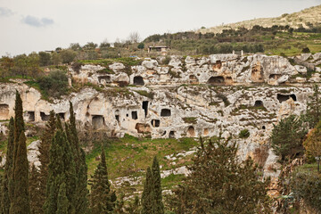 Gravina in Puglia, Bari, Italy: landscape of the canyon wall with the ancient cave houses dug in the limestone rock