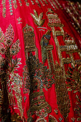 Obraz premium Intricate Embroidered Red Fabric: A Tapestry of Tradition, Craftsmanship, and Vibrant Color for Textiles, Fashion Design, and Cultural Appreciation Art