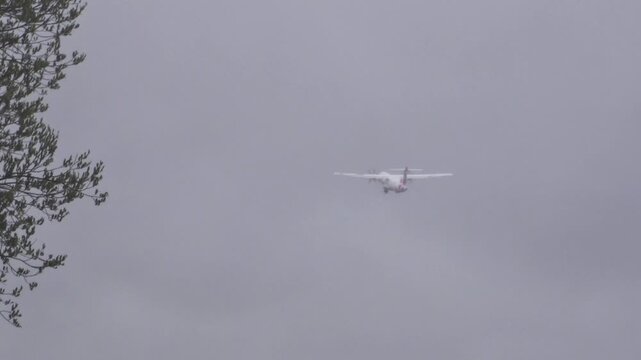 turboprop cargo aircraft climbs away runway oslo airport landing gear still visible ascends into low mist above forest lined airfield from norway gardermoen propeller freight ascent 