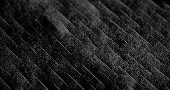 Macro Black Texture with Diagonal Grooves. Slow panning footage across a dark matte surface featuring parallel linear ridges, revealing subtle depth through shifting shadows and highlights.