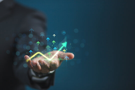 The concept of business, finance, and investment involves business people using digital tools from financial data analysis systems, graphing economic growth, and AI to determine business strategies an