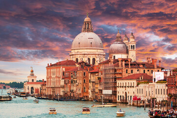 Naklejka premium St Mark’s Basilica (Basilica di San Marco) in Venice, Italy, with a scenic canal view and classic Venetian architecture. Iconic landmark at Piazza San Marco featuring Byzantine domes, ornate marble fa