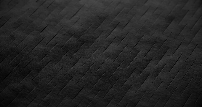 Macro Black Texture with Diagonal Grooves. Slow panning footage across a dark matte surface featuring parallel linear ridges, revealing subtle depth through shifting shadows and highlights.