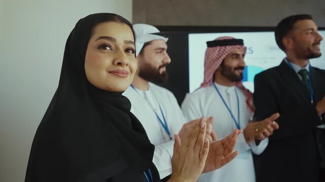 Western and emirati businesspeople in traditional arab attire participating in a conference with ceo, collaborating and taking notes in modern office environment