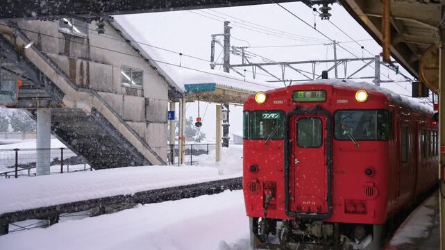 Red Train Locomotive on Tracks, Covered in Snow at Kinosaki Onsen Japan