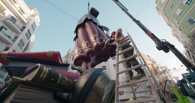 Street installation of a Fallas monument in Valencia, Spain. Workers assembling the large-scale sculpture before the official &ldquo;plant&agrave;&rdquo; during Las Fallas festival.