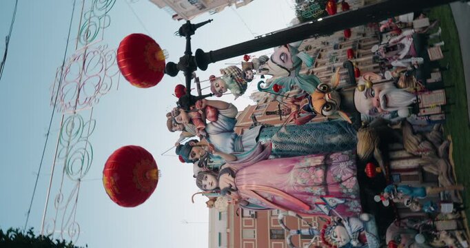 Large Fallas monument displayed in the street during Las Fallas festival in Valencia. Colorful and satirical ephemeral sculpture in a public urban setting.