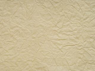 Obraz premium Beige crumpled paper texture. Blank soft page pattern for winter season Christmas festival card, new year designs decoration, background concepts, text, lettering, wall screen saver or other art work.
