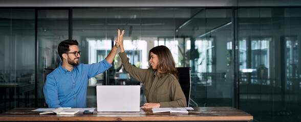 Happy successful business team of two executive partners employees giving high five supporting...