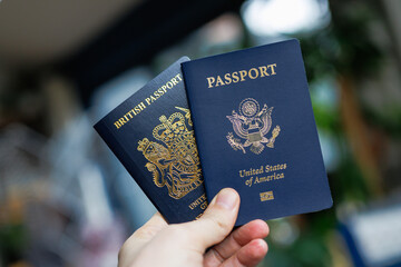 A close-up lifestyle image featuring a British and American passport placed side by side, symbolising dual citizenship