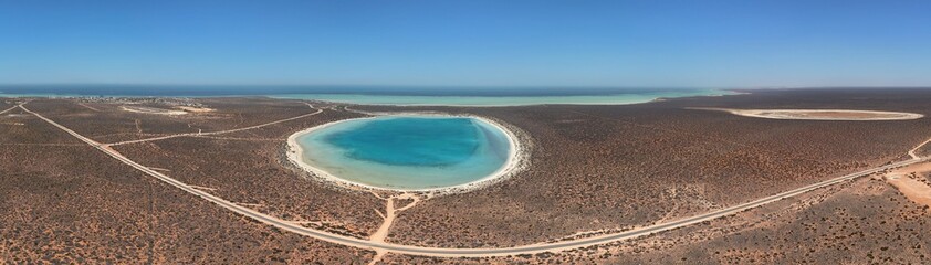 Aerial View of Turquoise Circular Little Lagoon and Sandy Beach in Arid Coastal Landscape of Shark Bay, Denham, Western Australia