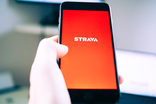 person opening Strava app on a phone