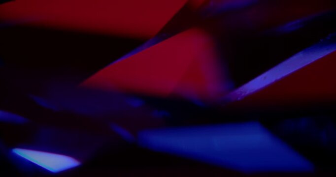 Abstract Red-Blue Geometric Light Play Seamless Loop. Dynamic interplay of vibrant crimson and cobalt triangular facets with shifting glows and reflections in motion.