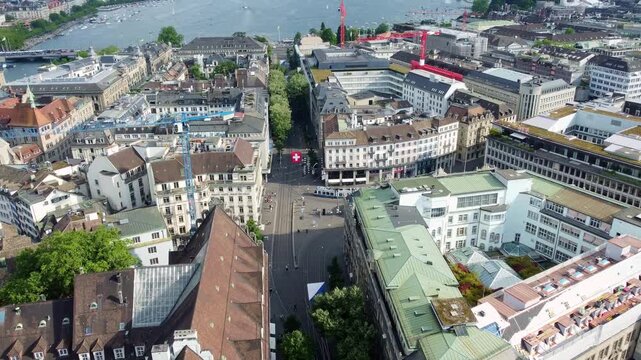 Zurich, Switzerland: Aerial drone footage of the famous Bahnhof street that crosses Zurich business and financial district in Switzerland largest city with lake Zurich in the background