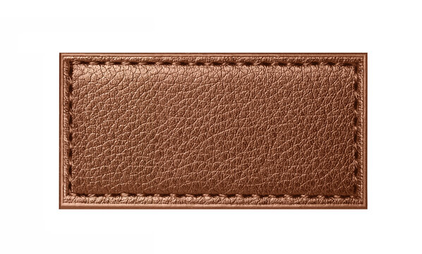 Brown leather patch label isolated on white background. Textured natural leather surface. Stitched rectangle tag detail. Blank branding badge element. Fashion garment accessory. Copy space template.