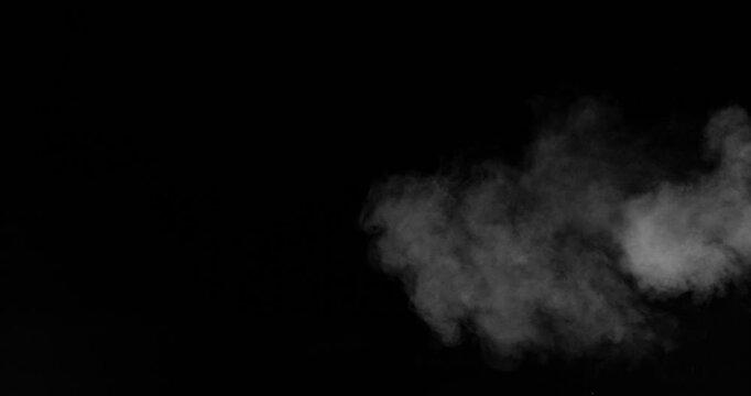 Super slow motion smoke effect of visible breath exhalation in icy conditions, filmed at 500 fps on a high-speed camera. Isolated on black background, ideal as realistic VFX overlay.