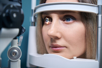 Close up of head of young patient fix in tomography in optical coherence equipment