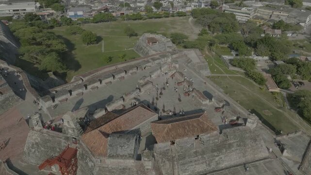 drone flying around main tower of castillo de san felipe during the day going towars a small house in the back of the castle n going around