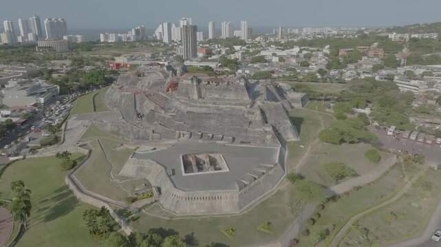 drone flying forward towars castillo de san felipe during the day from est side to back part to main flag closer to the west side n overlooking the sea
