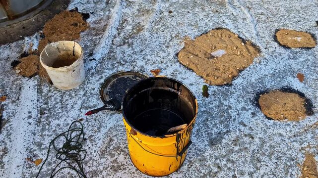 Applying bituminous products to repair a damaged roof surface. Waterproofing materials and process