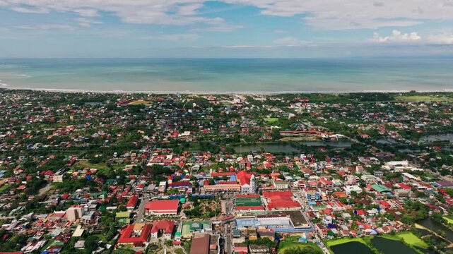 Aerial establishing shot of Lingayen coastline, sea horizont, cloudy sunlight