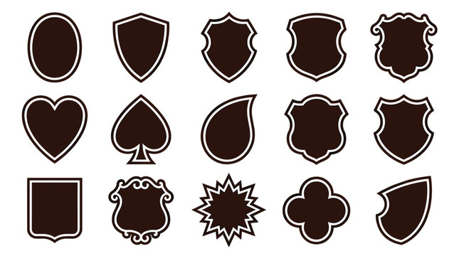 Collection of dark brown shield shapes and emblem templates in various classic and ornate styles, including heart, spade, and starburst forms for creating custom logos or badges